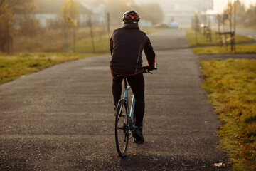 man on a blue bicycle in the morning cold season goes to work