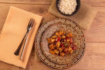chess chicken in brown dish on wooden background - chinese food