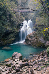Naklejka na ściany i meble Misty waterfall in Vintgar Gorge in Slovenia