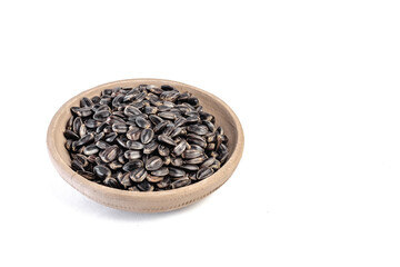 Sunflower seeds in a plate on a white background