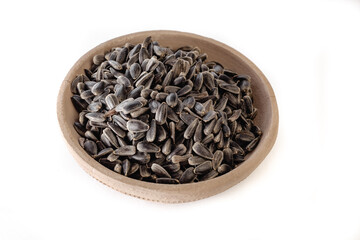 Sunflower seeds in a plate on a white background