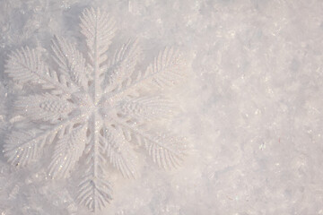 artificial snowflake in the snow, christmas and new year toy, background