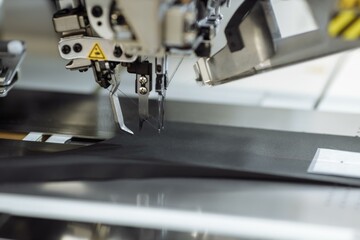 sewing machine scribbling fabric. tailoring at the factory