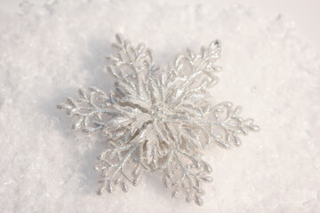 artificial snowflake in the snow, christmas and new year toy, background