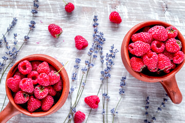 fresh raspberry and dry lavander in rustic design wooden background top view