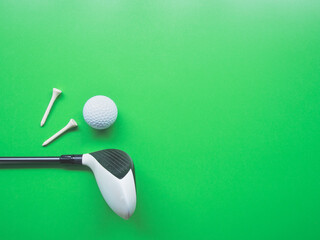 Golf equipment flat lay on green background. Top view