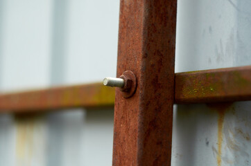 Rusty nut and bolt on the fence post