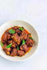 Indian Lamb Masala in a Bowl on White Background Vertical Photo