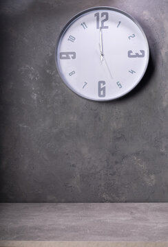 wall clock at concrete or putty background