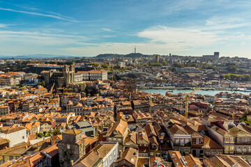 Fototapeta na wymiar A view southward towards the cathedral across the roof tops of Porto, Portugal from the Clerigos Tower on a sunny afternoon