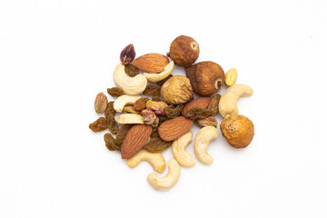 A variety of nuts  are placed on the white background at the center of the image, top view, flay...