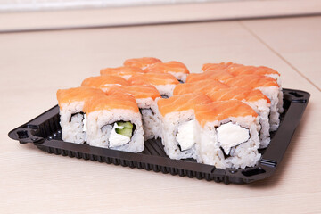Philadelphia classic. Salmon, Philadelphia cheese, cucumber, avocado, tobiko. Japanese sushi