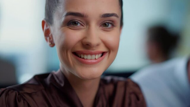 Young businesswoman laughing at camera.Smiling female employee looking at camera