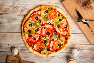 Top view on vegetable pizza with olives and pepper