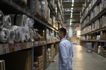 Young boy buying home furniture in a factory