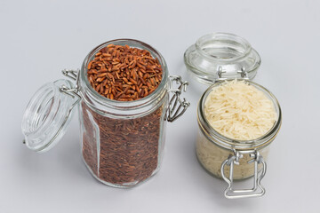 Obraz na płótnie Canvas Red and white rice in glass jars.