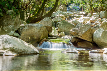 View of a small waterfall in Corsican mountain stream. High quality photo