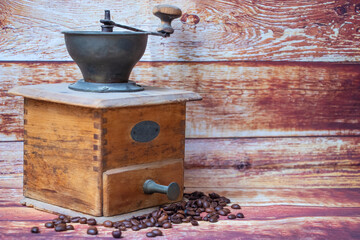 coffee grinder and coffee beans on a wooden background