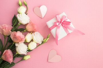 Top view of  gift box, white and pink flowers on the pink  background