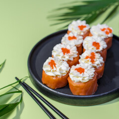 Sushi set on green background with leafs