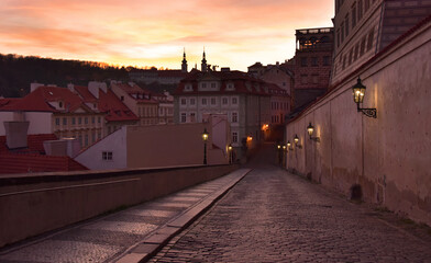 Old Prague street at sunset stock images. Ancient architecture in Prague. Evening Prague old town. Old houses in european city images. Ancient street in Czech Republic. Mysterious Prague stock images