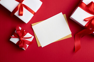 Greeting card mockup with gift boxes on red background