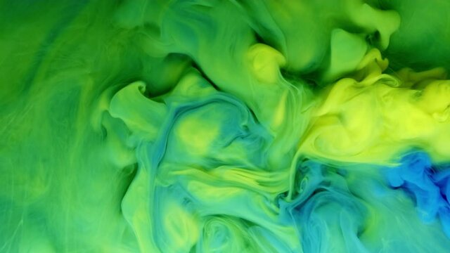 Fluid art drawing footage. trendy acryl texture with flowing effect. Liquid paint mixing backdrop with splash and swirl. Detailed background motion with yellow and blue overflowing colors.