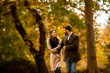 Young couple walking in the autumn park