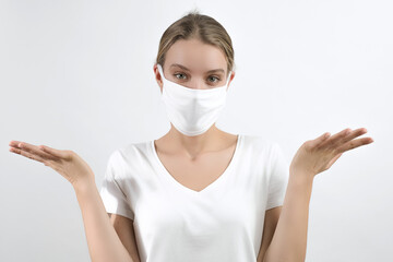 confused young girl shrugging shoulders, making helpless gesture with hands, throws up her hands in...