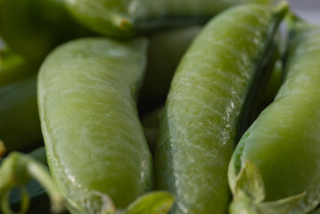 fresh green peas on a plate ready to peel and eat