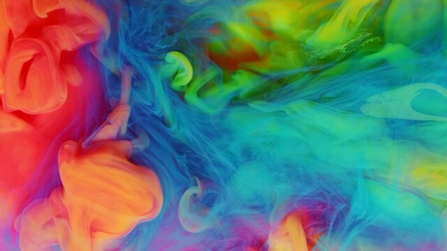 Ink in water exploding mixing in slow Motion. Paint splash swirling underwater. Colorful clouds, abstract color smoke dynamic flow