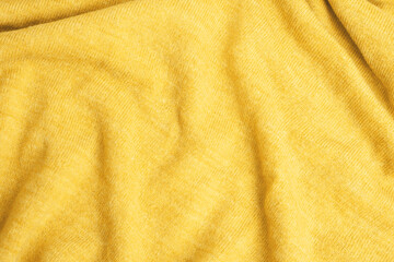 Close up of yellow knitted textured background.