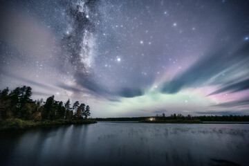 The Milky Way, auroras and fast moving clouds