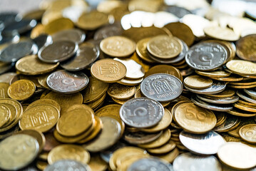 Collectible coins scattered on a surface. Golden and silver coins. View from above.