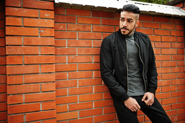 Portrait of stylish arab beard man wear grey turtleneck and black jaket. Arabian model guy against...
