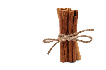 Cinnamon sticks stand connected and isolated on a white background.
