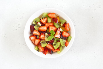 Fototapeta na wymiar Healthy food fruit salad from kiwi and strawberry.
