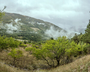 Greco peak green slopes and Barrea lake aerial, Abruzzo, Italy