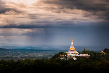 Scenery Dramatic in The Rain drop Sunset Sky on Mountain Keaw Chedi, Thaton Temple in Chiang Mai Province , Thailand.