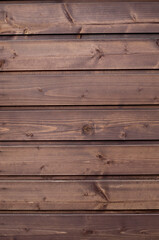 Fototapeta na wymiar New dark brown wooden wall close