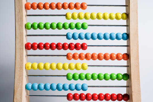 Close-up Of Multi Colored Abacus Against Blue Background