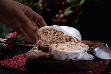 Traditional Stollen raisin cake for Christmas treats with nuts, spices and dried fruits.