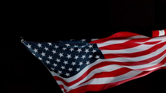 Super slow motion of waving flag of USA isolated on black background. Filmed on high speed cinema camera, 1000fps.