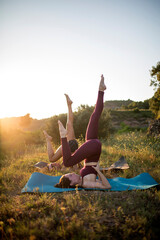 Two girls practicing yoga on the mountain