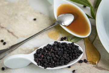 A cup of tea, honey, and lemons. Elderberries.