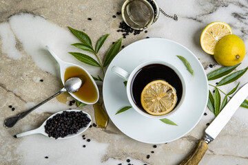 A cup of tea, honey, and lemons. Elderberries.