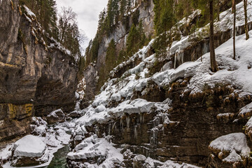 Fototapeta na wymiar snow covered rocks in the forest