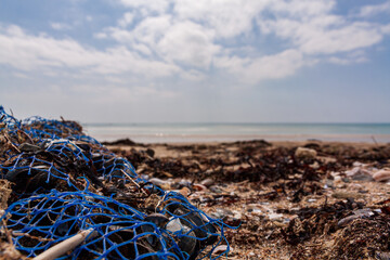 nets on the beach, plastic pollution, cloudy day