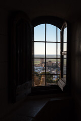 View of the medieval village of Belmonte through a window of the castle at sunset, Cuenca, Spain