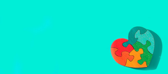 Wooden multi-colored handmade heart in the form of a puzzle. Zero Waste concept of using environmentally friendly natural materials.